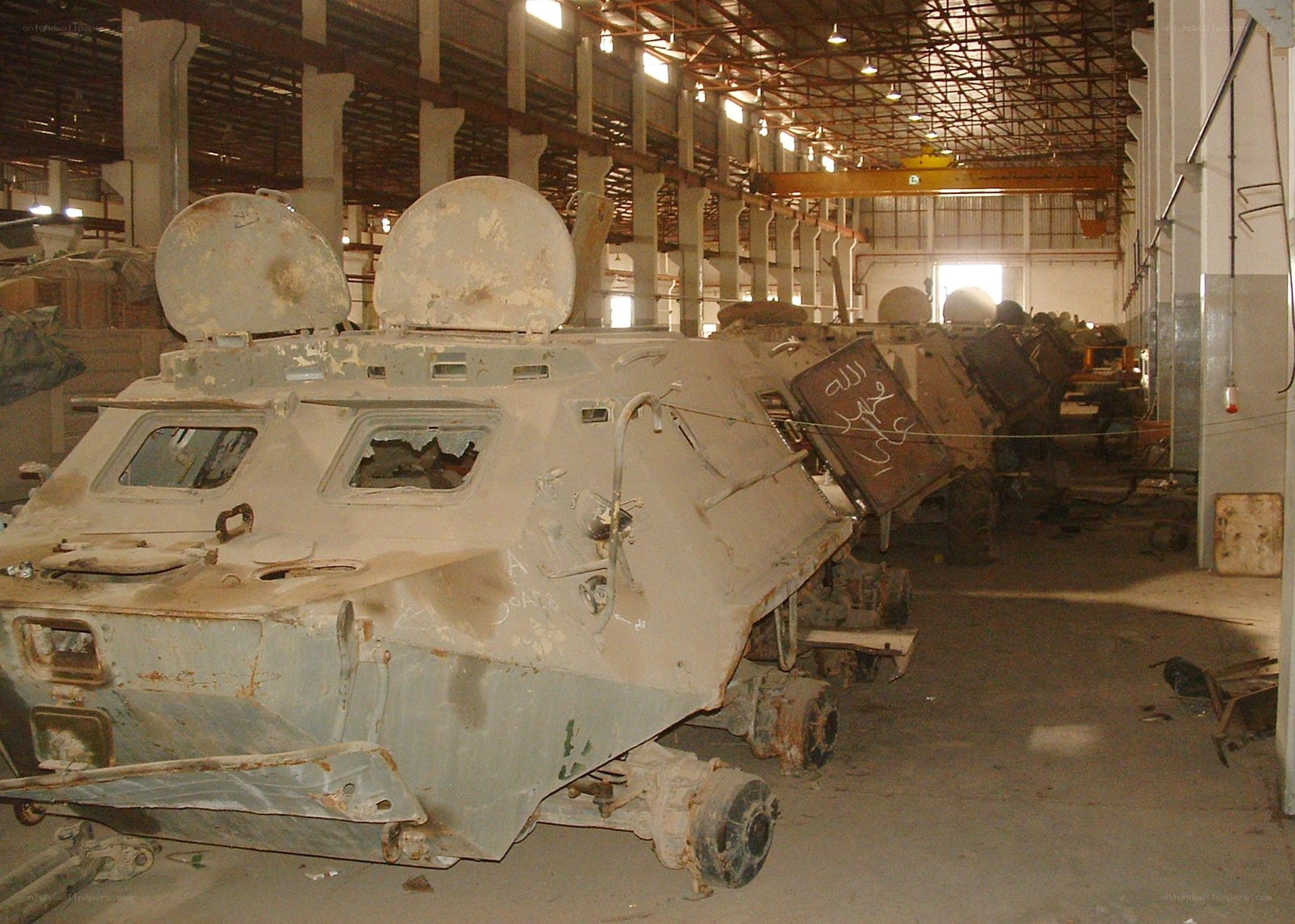 Damaged armored vehicles in warehouse