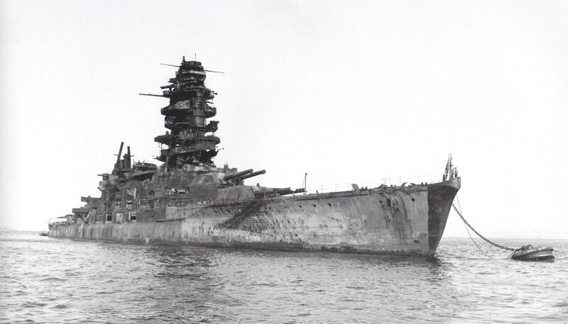 Damaged battleship in harbor