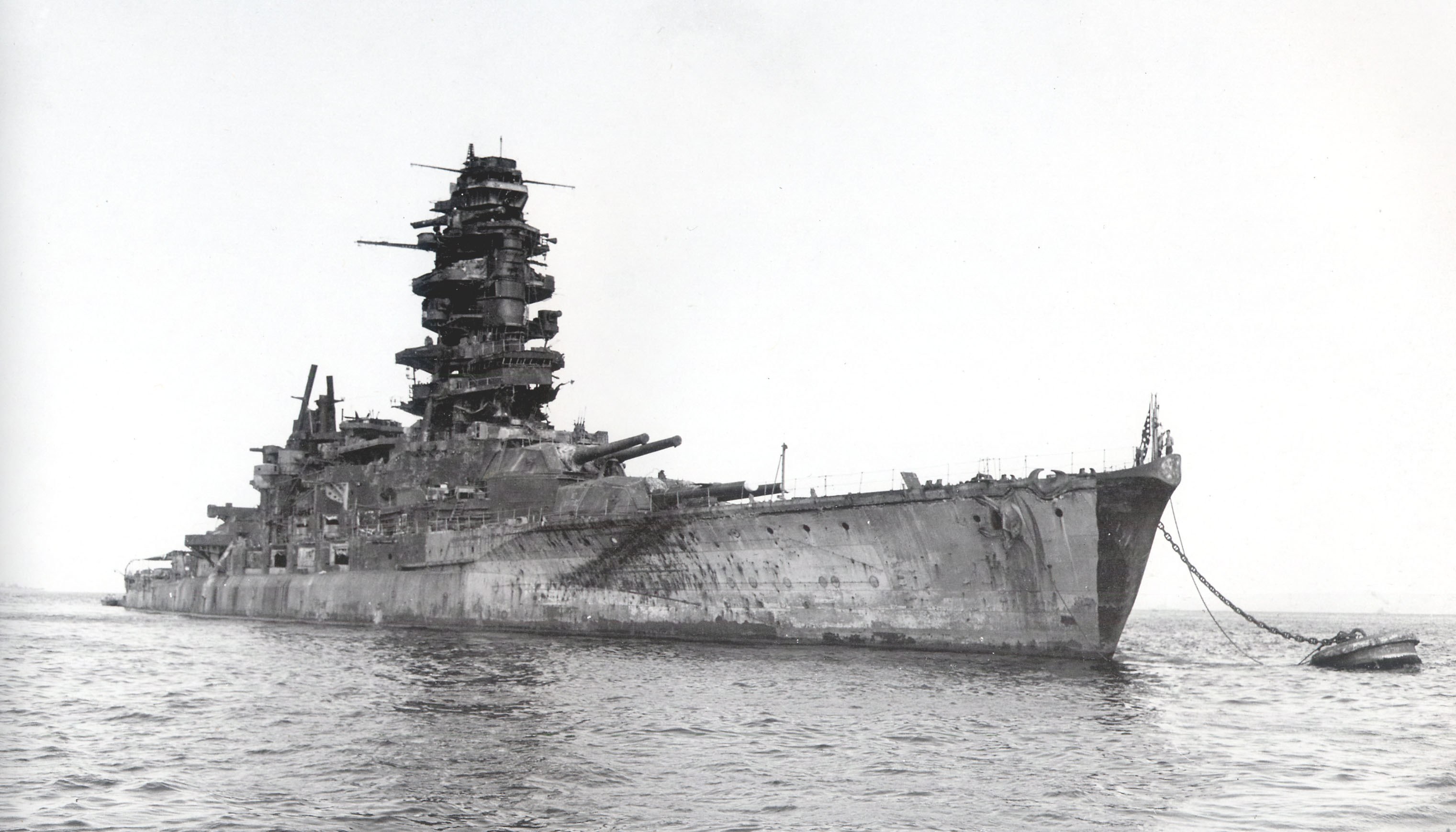 Damaged battleship in harbor