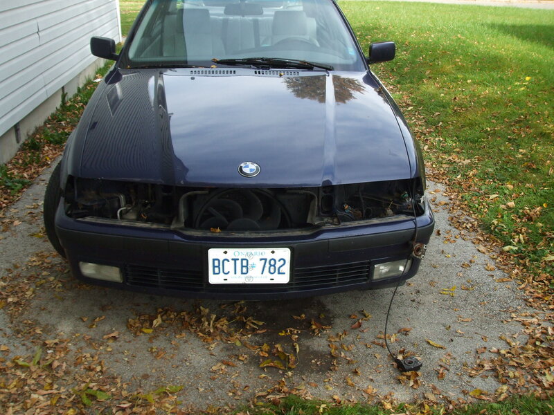 damaged blue bmw car