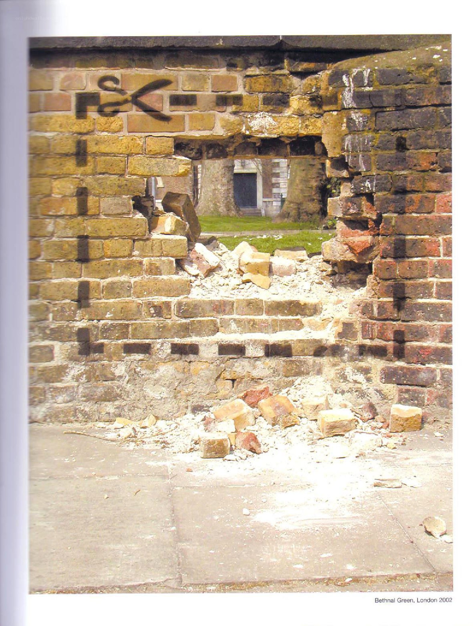 Damaged brick wall in Bethnal Green