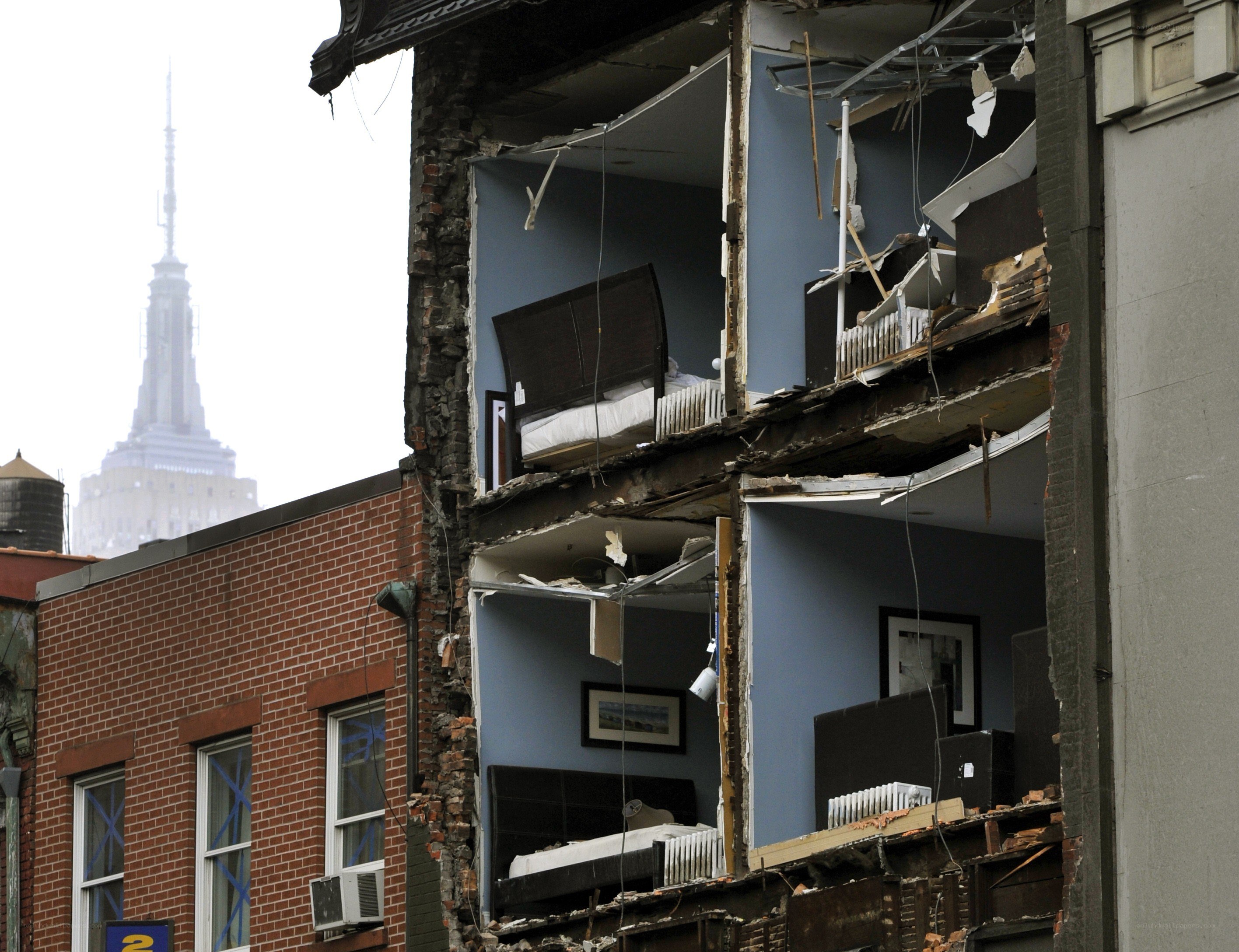 Damaged building with Empire State Building in background