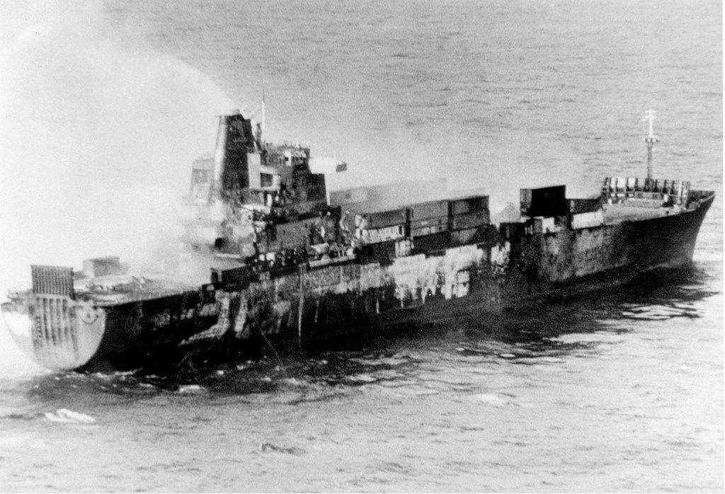 Damaged cargo ship at sea