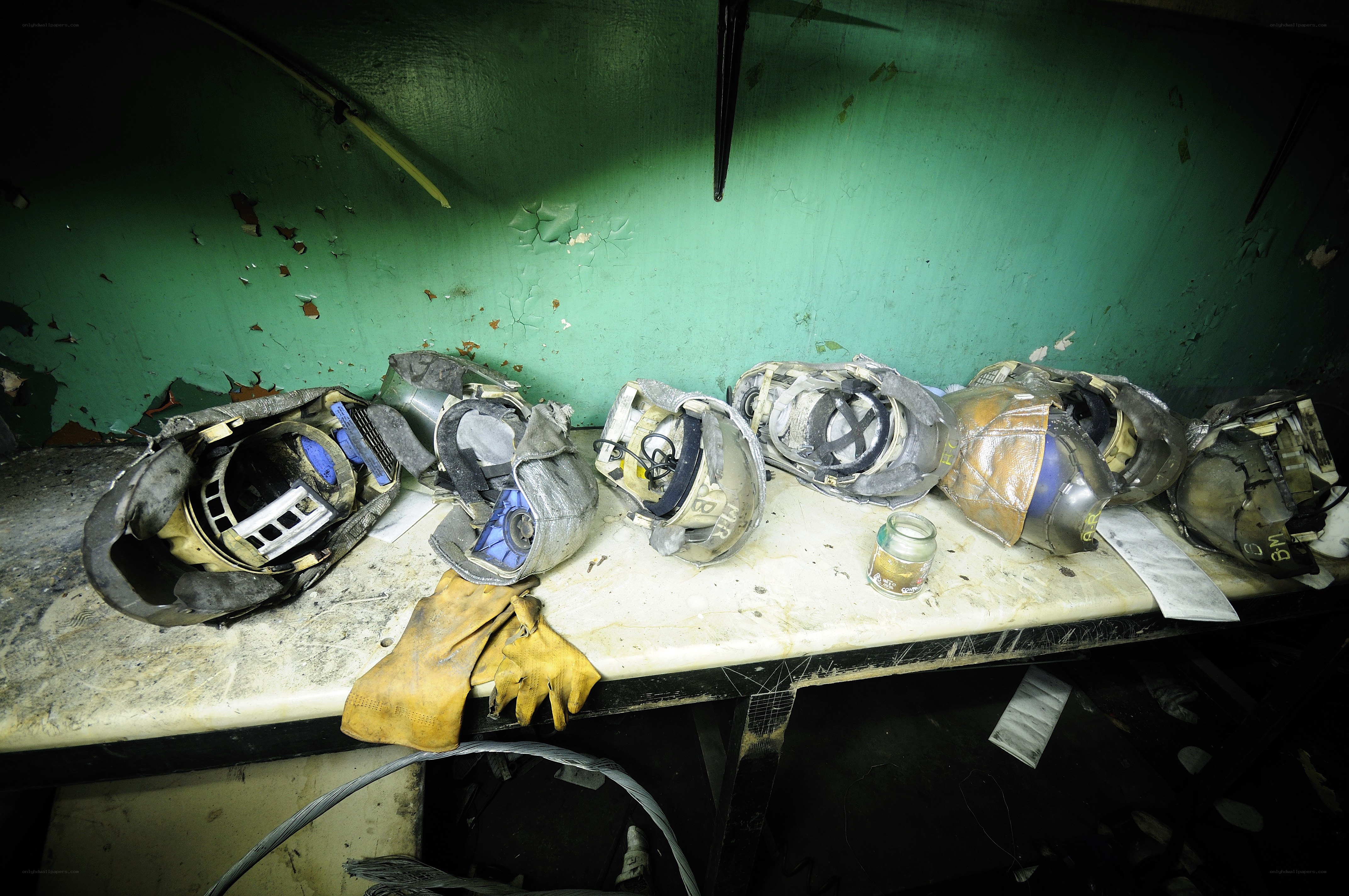 Damaged helmets on a workbench