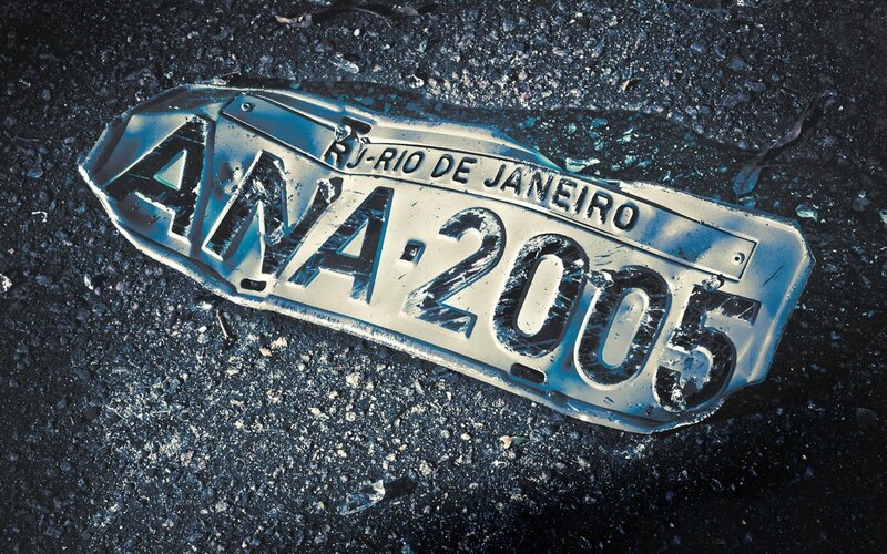 Damaged license plate on asphalt
