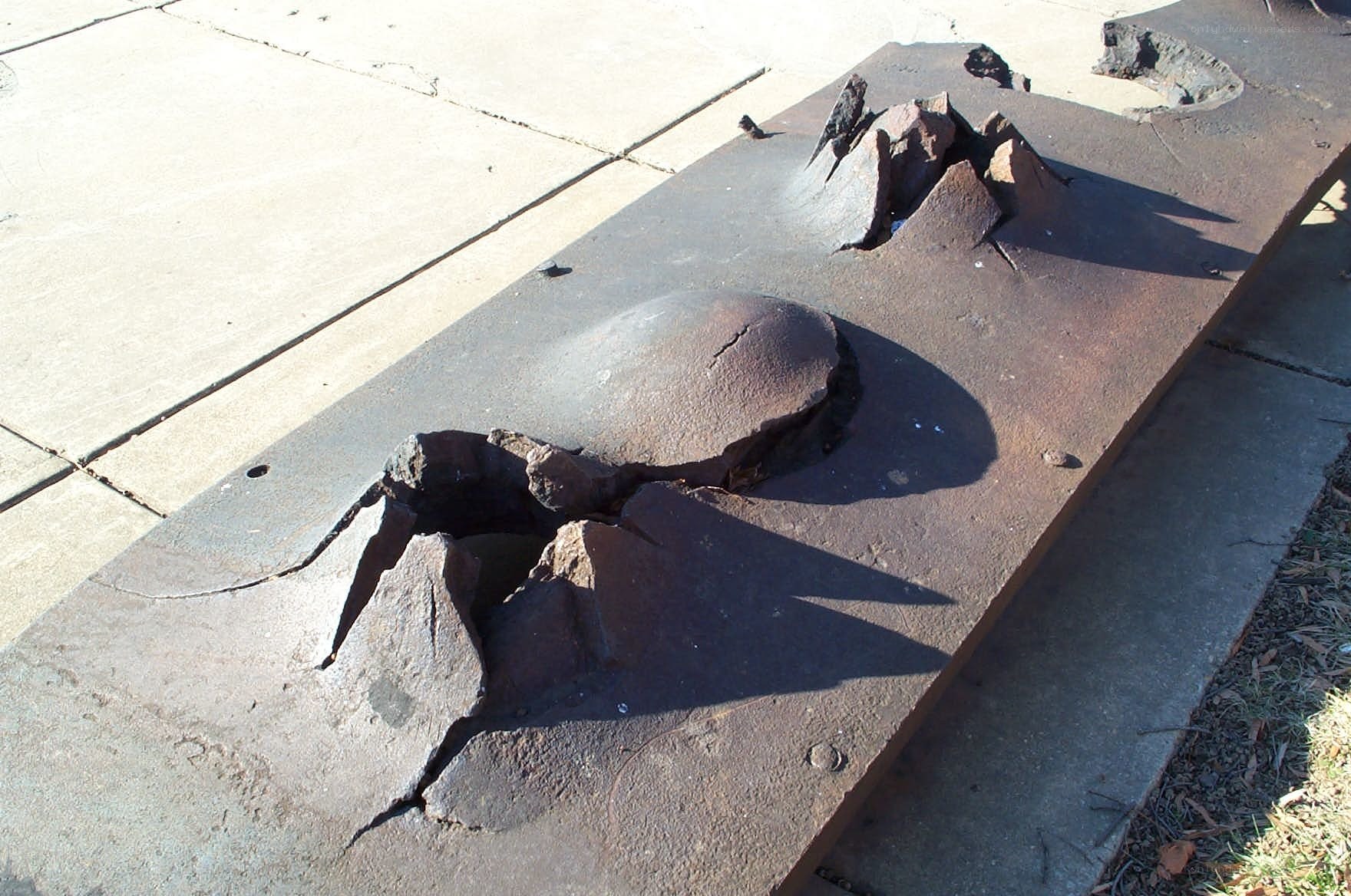damaged metal plate on sidewalk