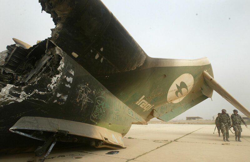 Damaged military aircraft on tarmac