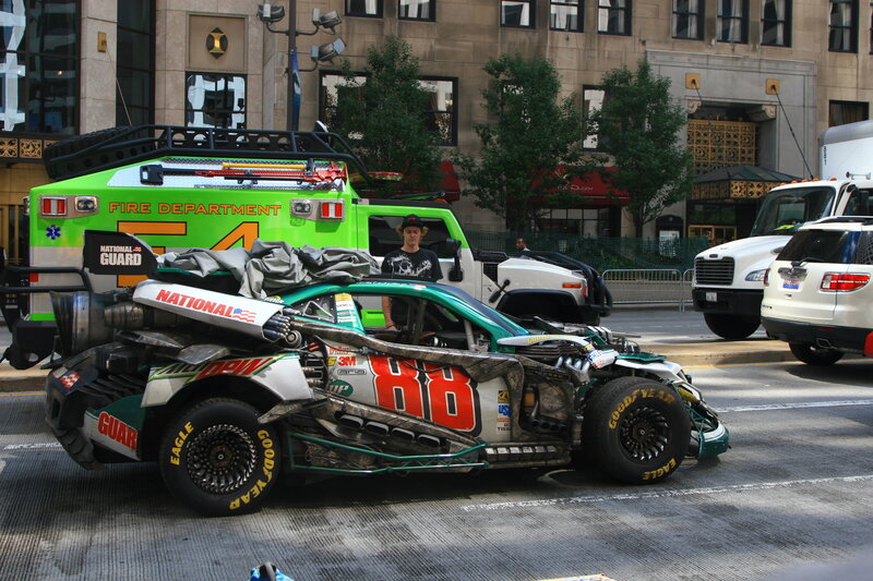 Damaged race car on city street