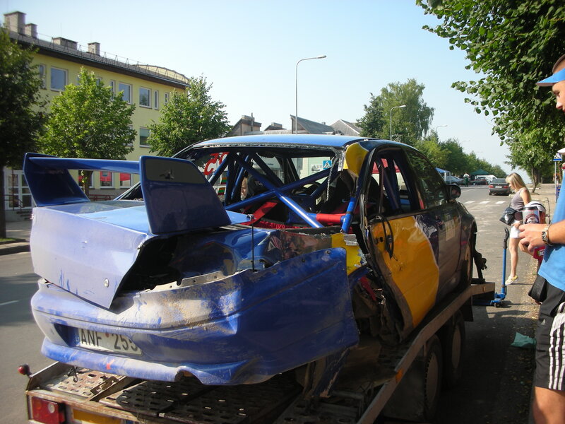Damaged race car on tow truck