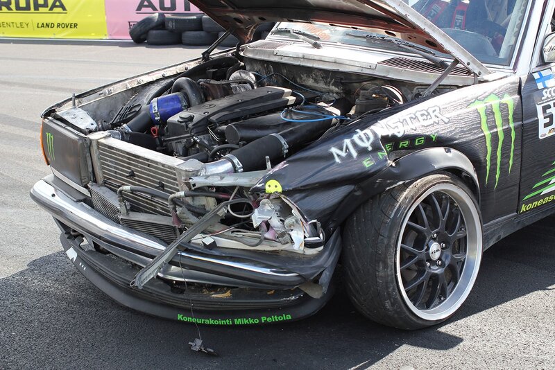 Damaged race car with open hood