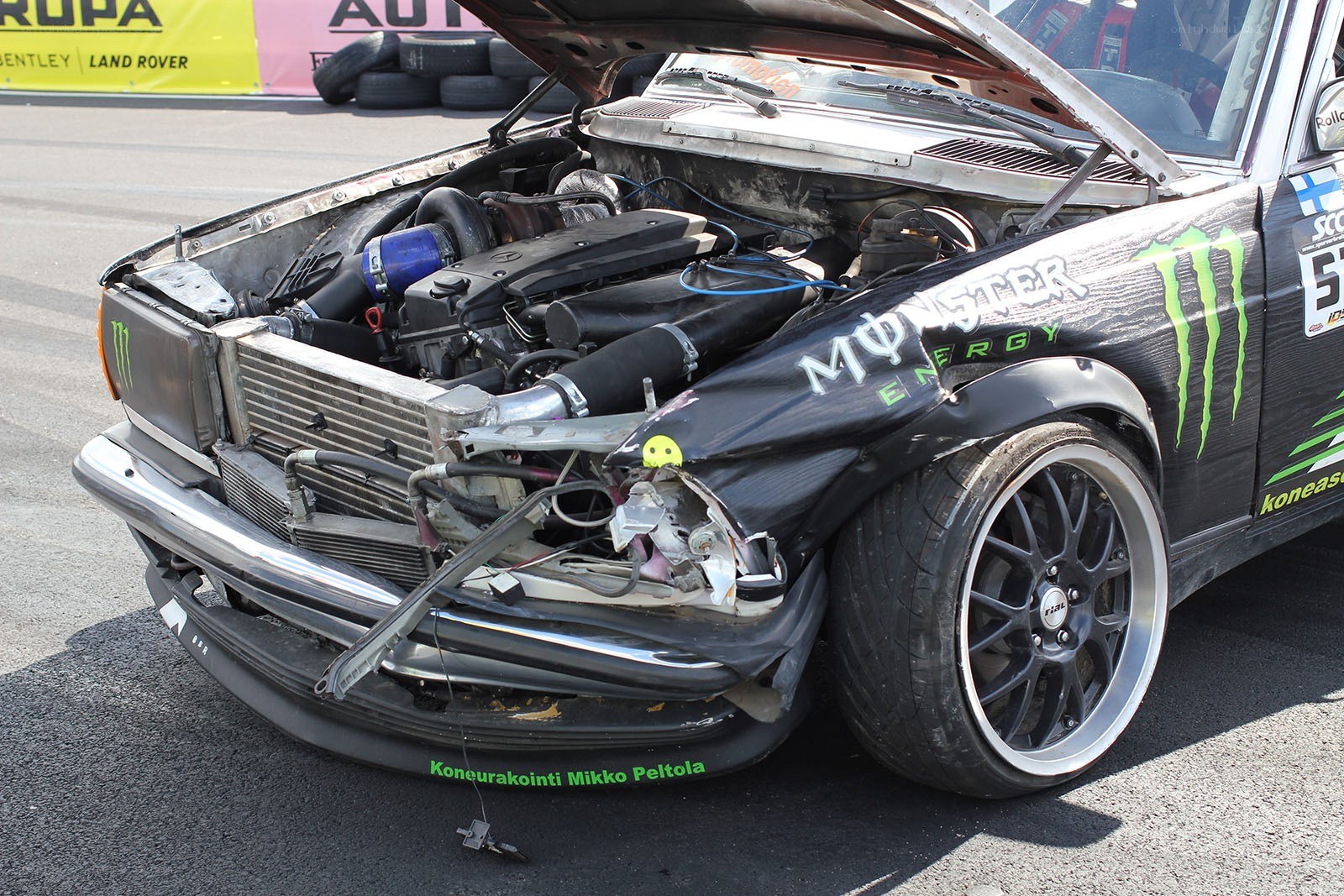 Damaged race car with open hood