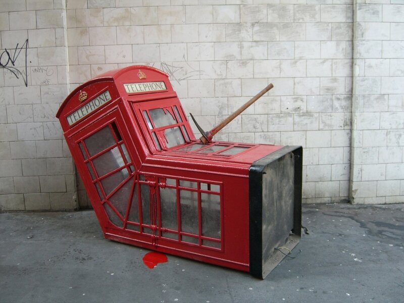 Damaged red phone booth