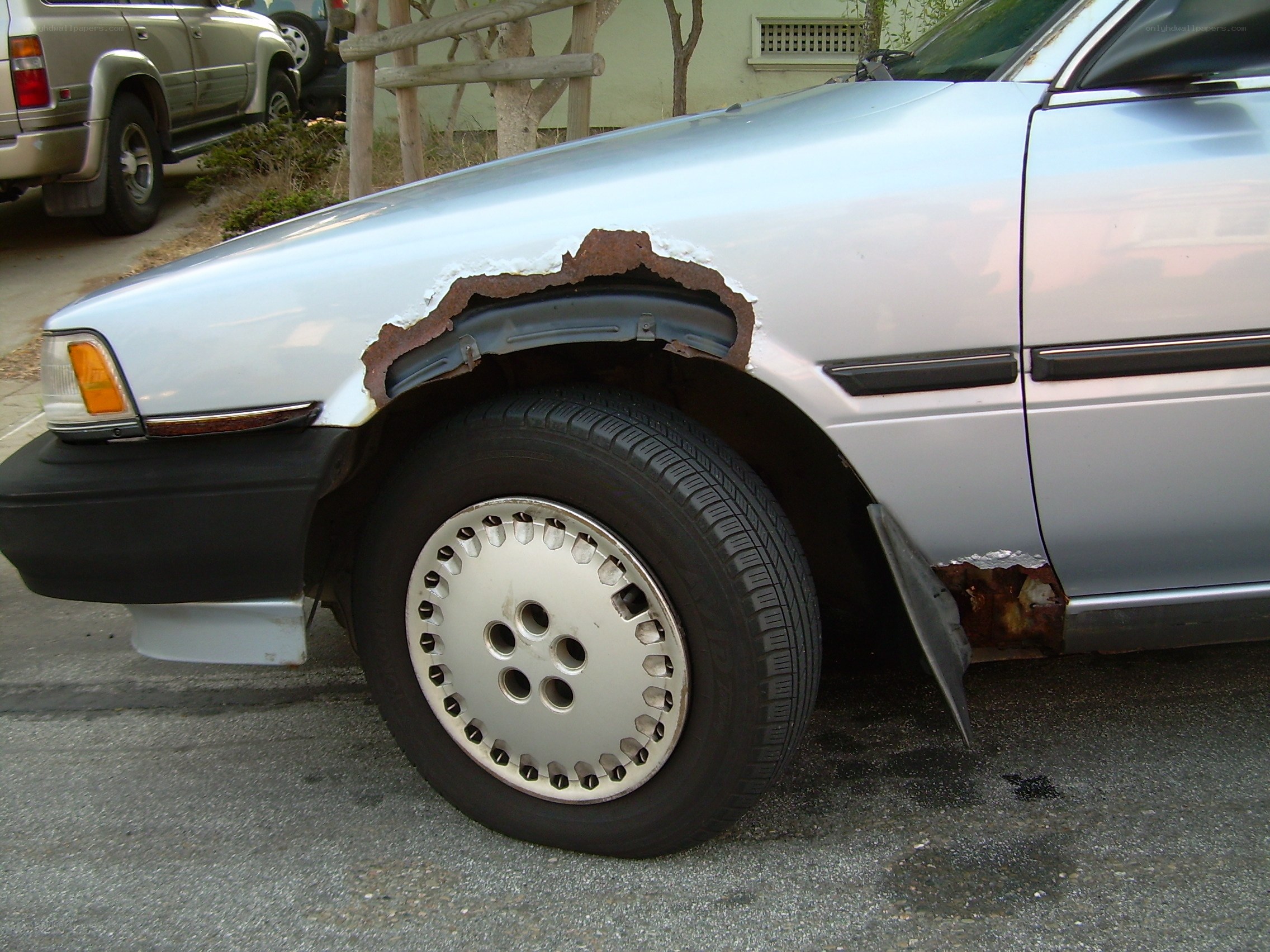 damaged silver car fender