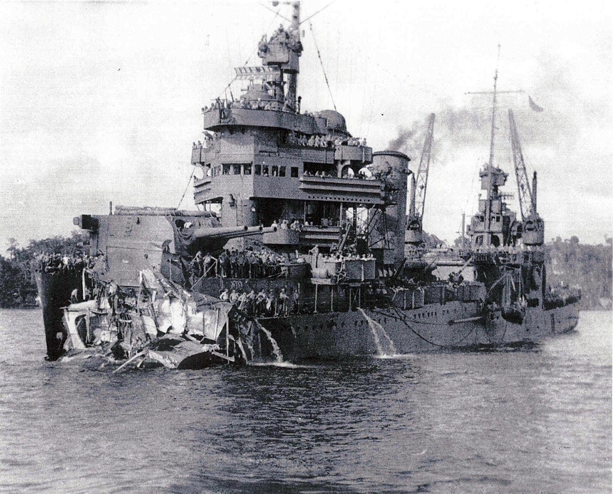 Damaged warship in harbor