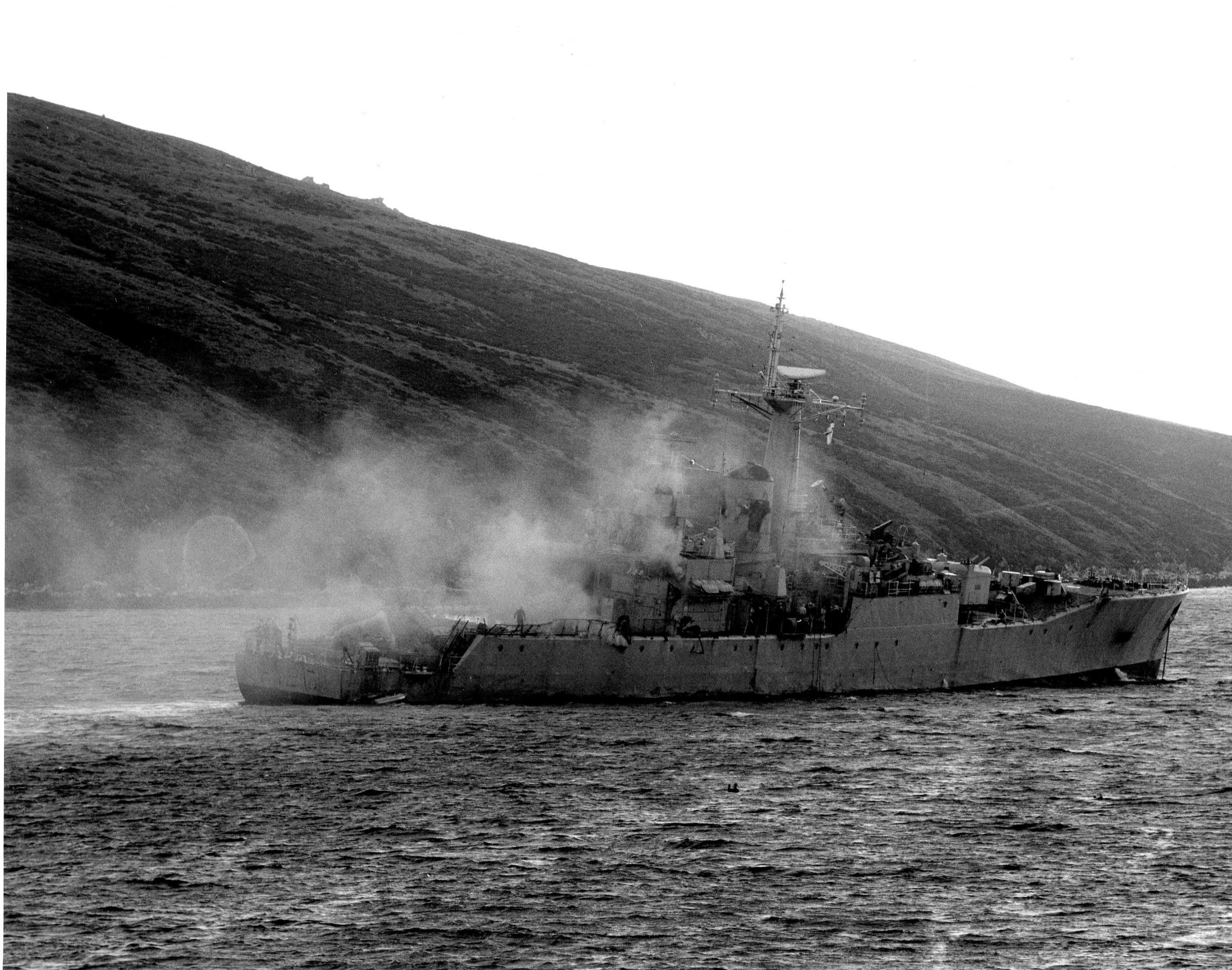 Damaged warship in harbor