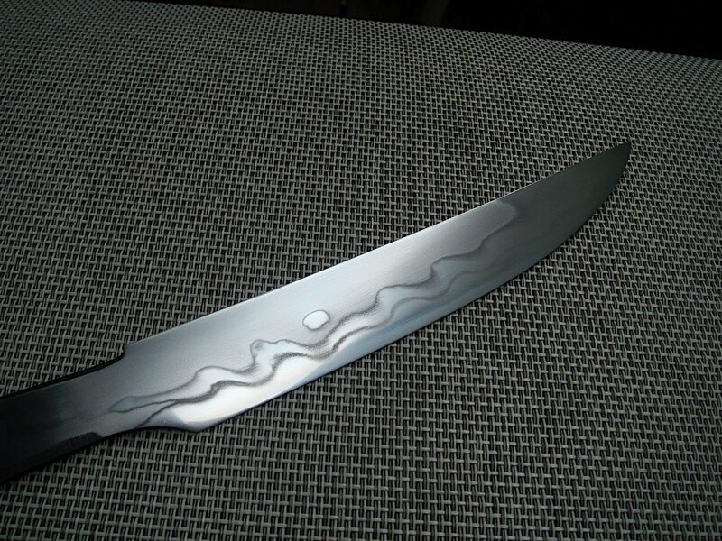 Damascus knife on mesh surface