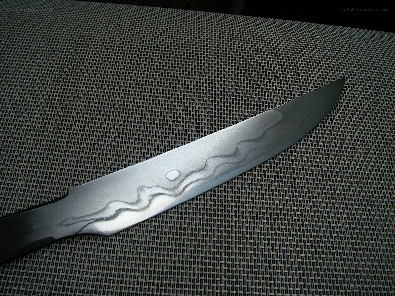 Damascus knife on mesh surface