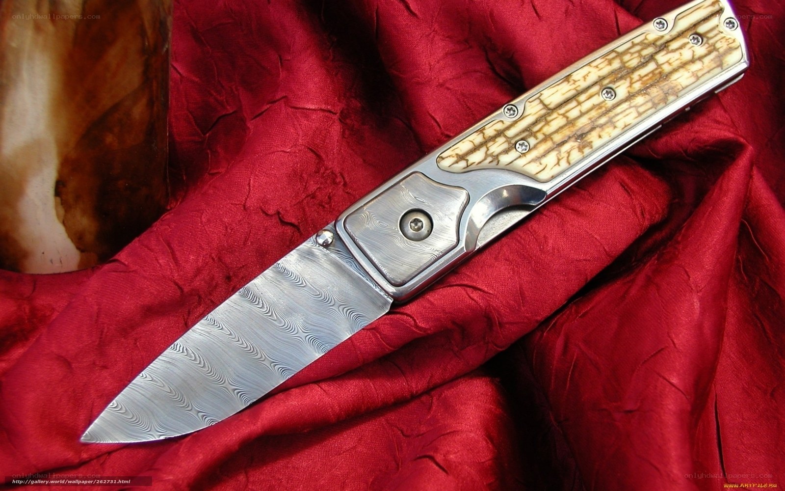 Damascus knife on red cloth