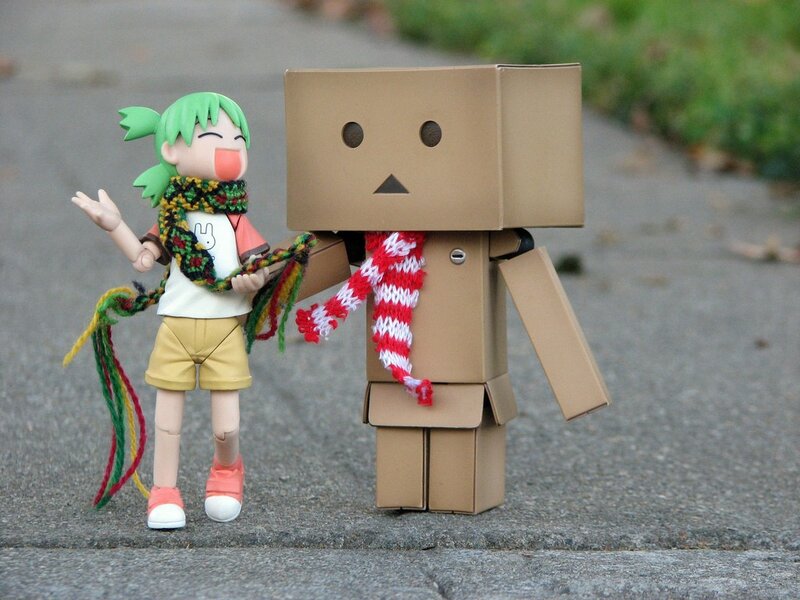 Danbo and a figurine on pavement