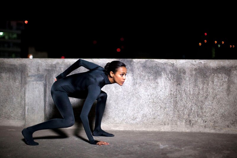 Dancer in black suit at night