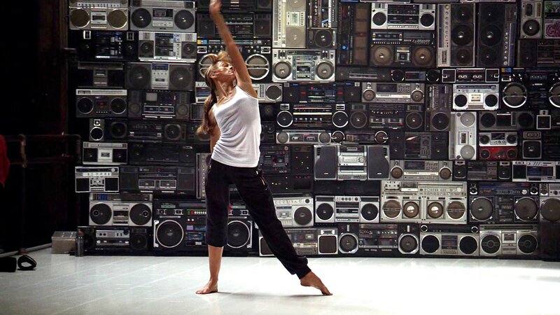 Dancer in front of boombox wall
