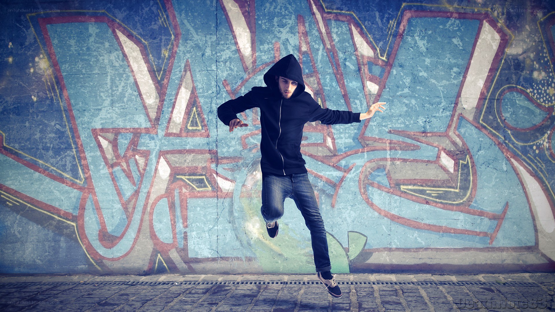 dancer in front of graffiti wall