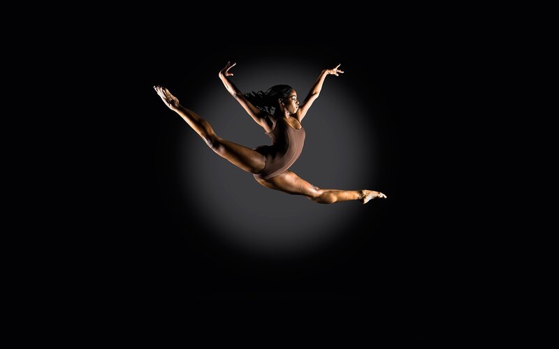 Dancer in Mid-air Leap — Black, Dramatic, Photograph