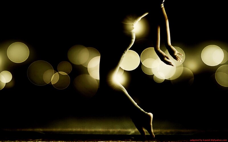 dancer in motion with bokeh lights