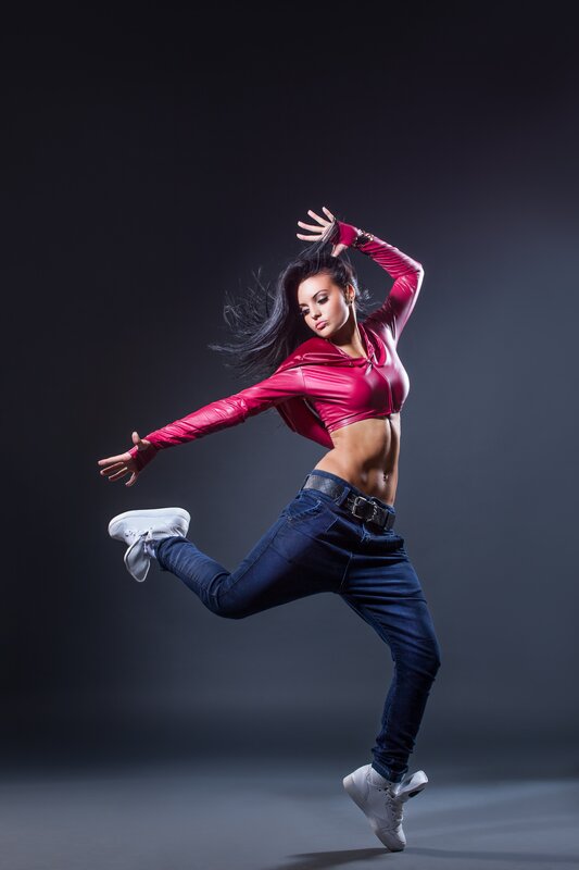dancer in red top mid-jump