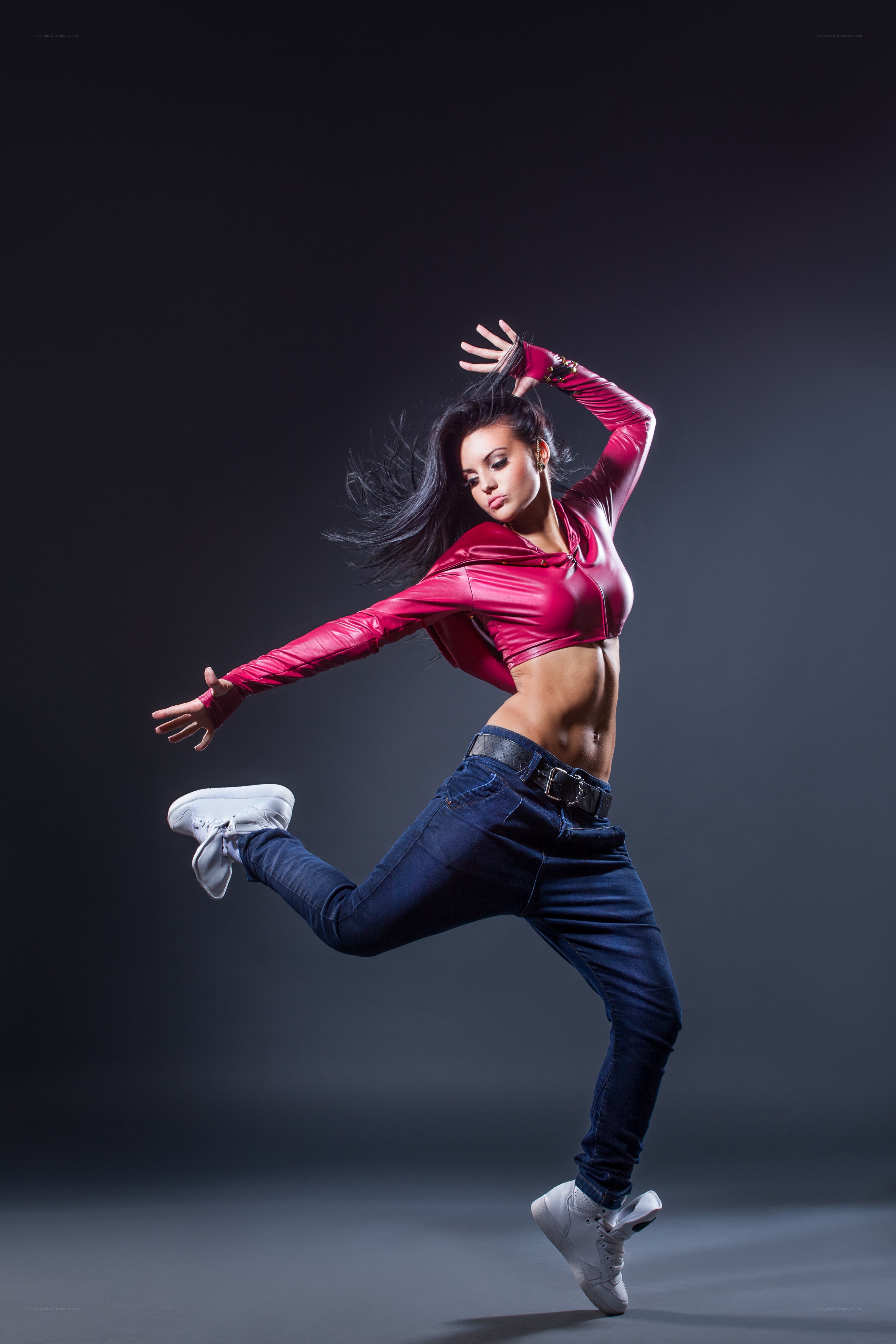 dancer in red top mid-jump