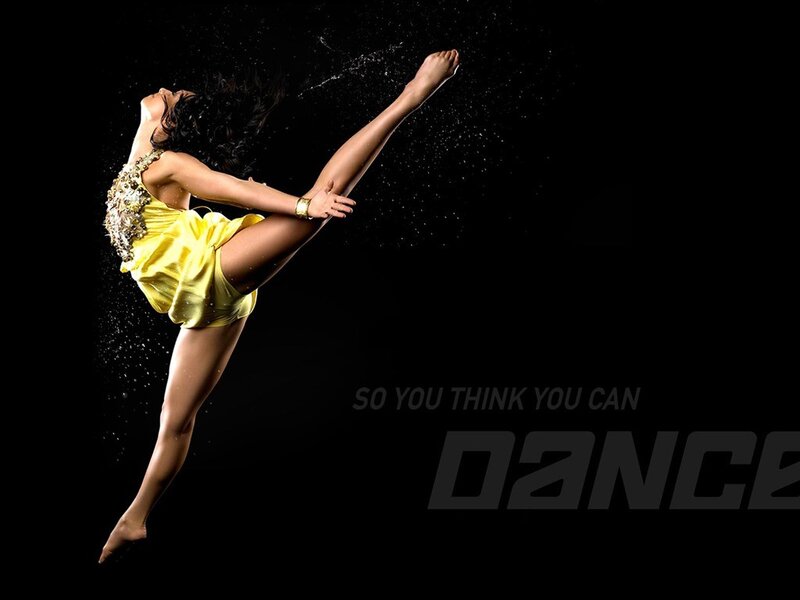 Dancer in yellow mid-jump