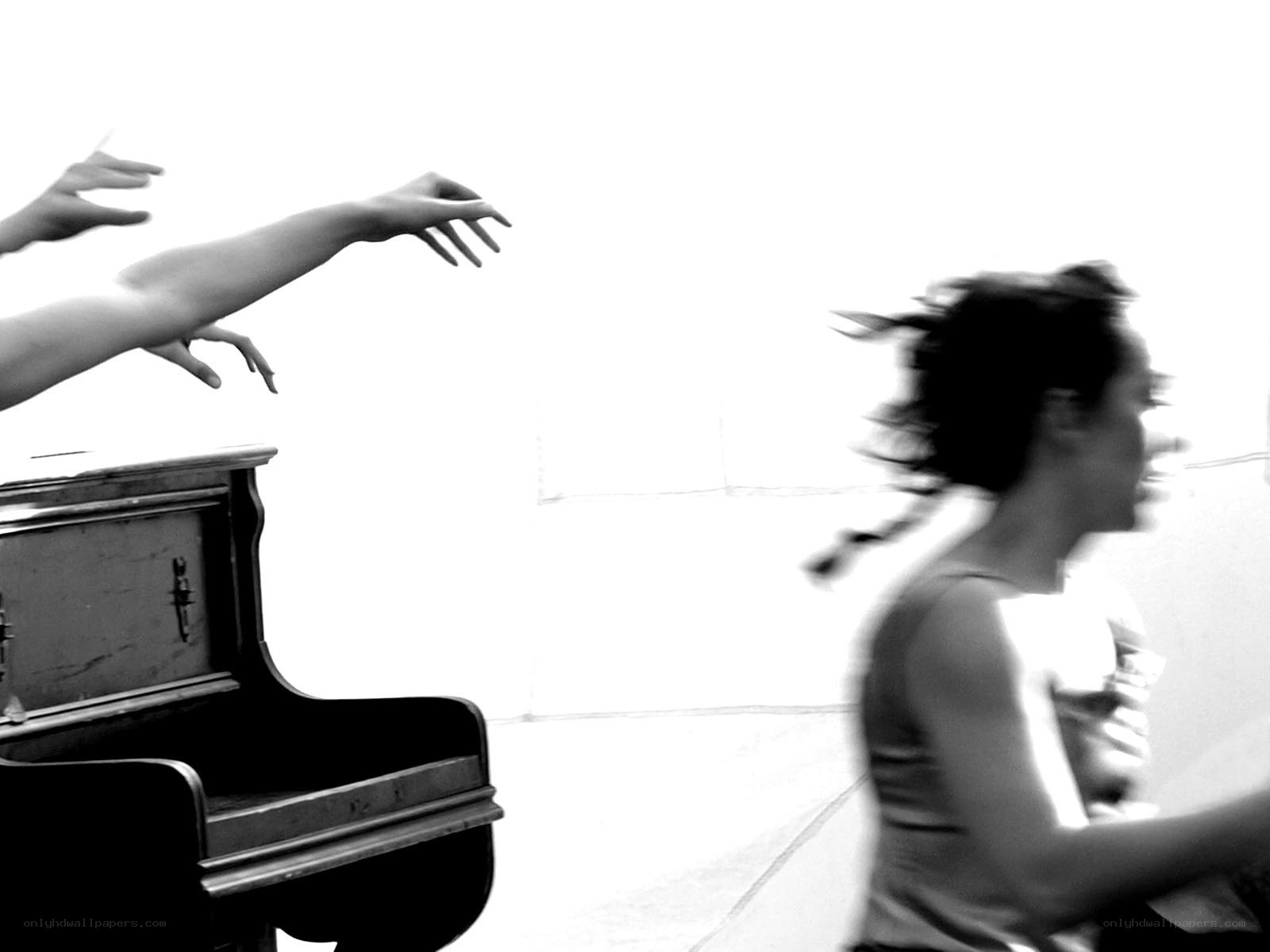 Dancer near piano with outstretched hands