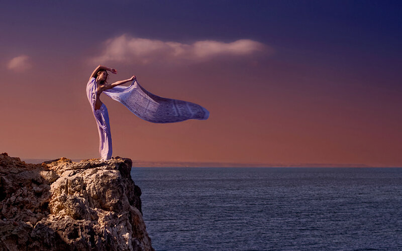 Dancer on a cliff at sunset