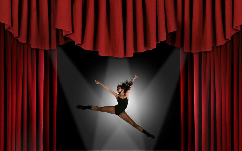dancer on stage under spotlight