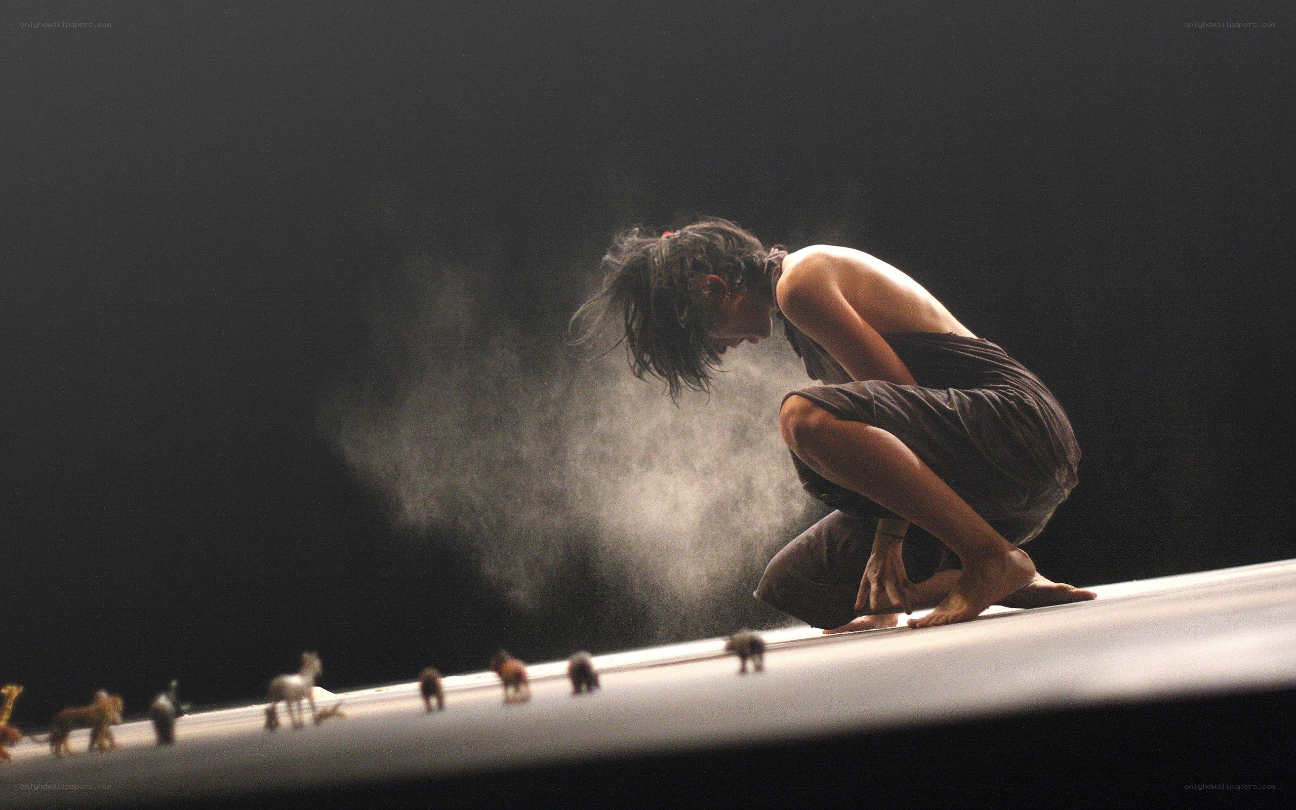 Dancer on stage with animal figures