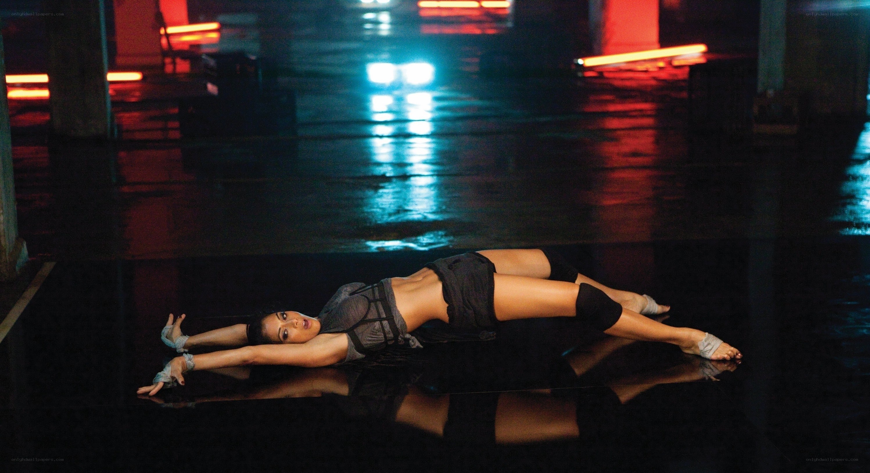 Dancer on wet floor at night