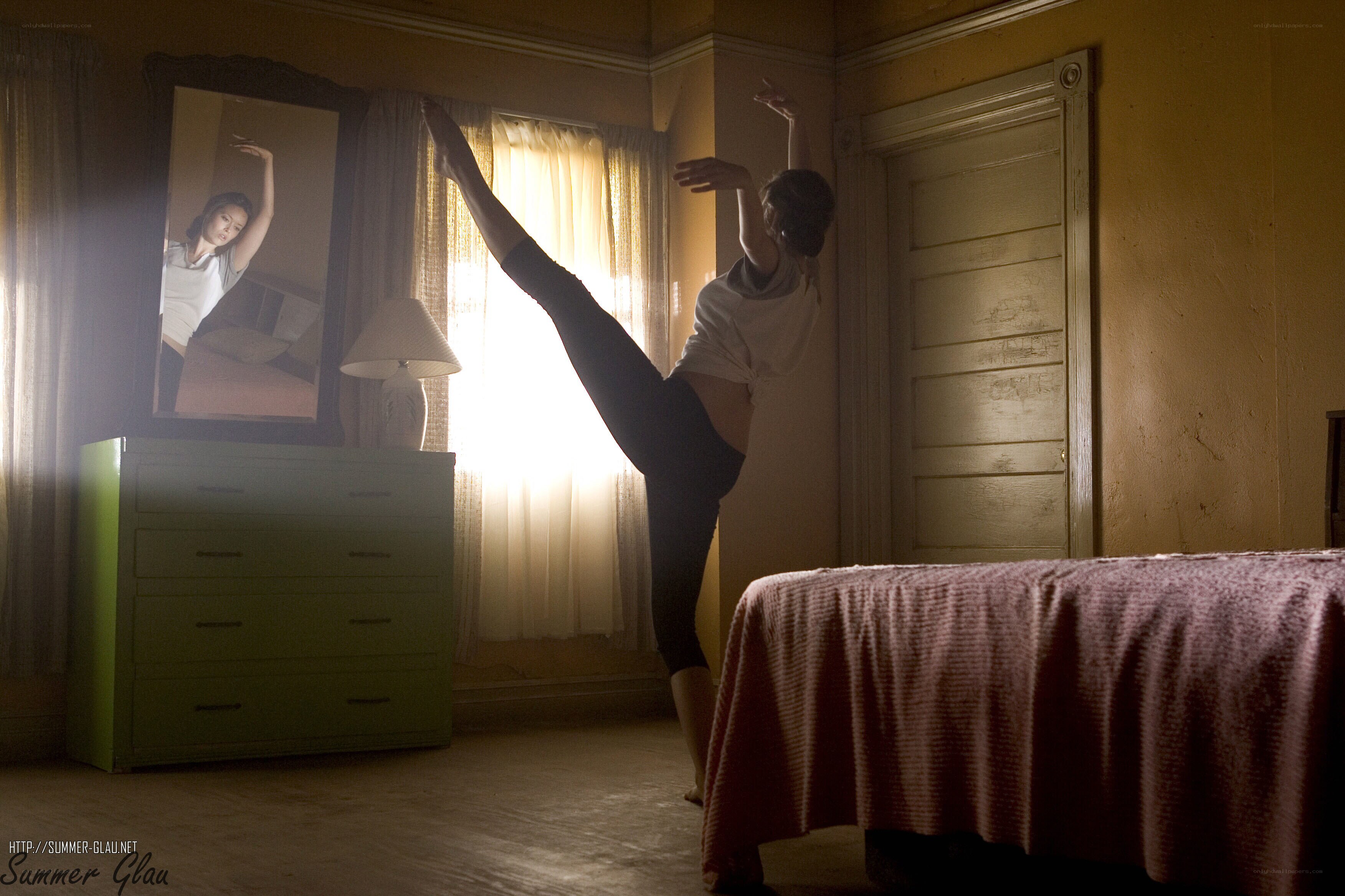 Dancer stretching in bedroom