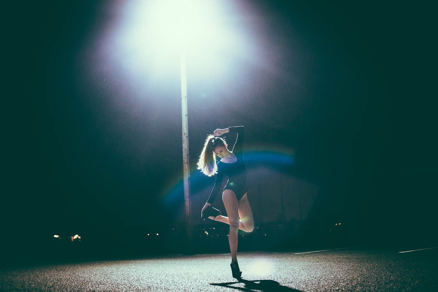 Dancer under streetlight at night