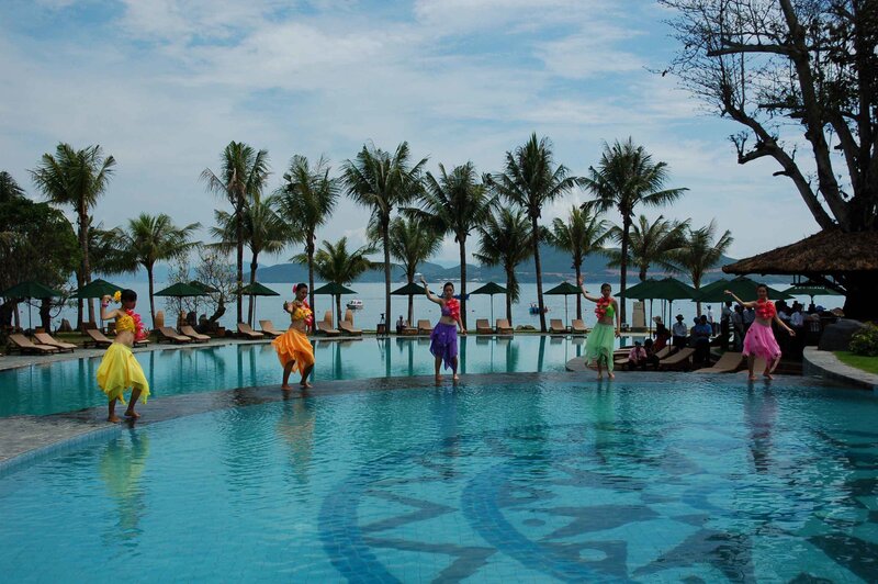 Dancers at a tropical resort pool