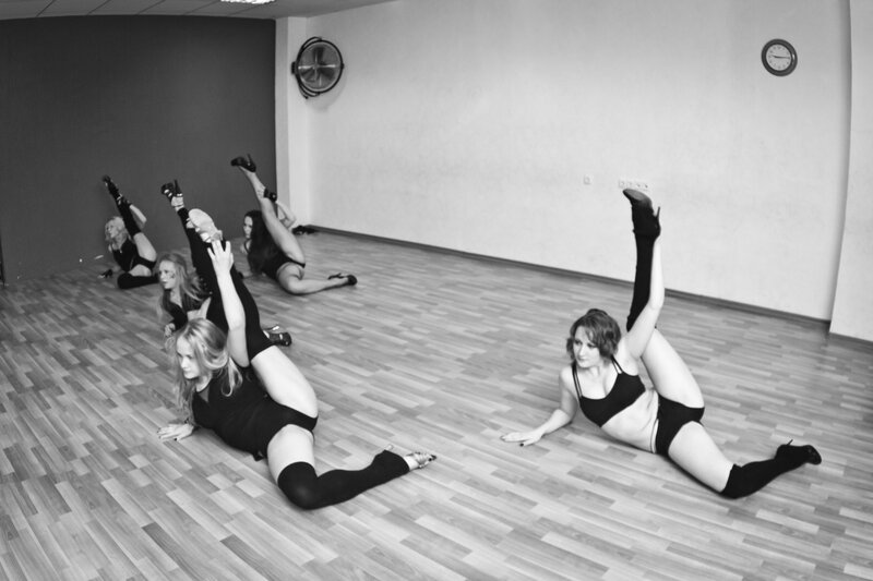 Dancers in a studio stretch