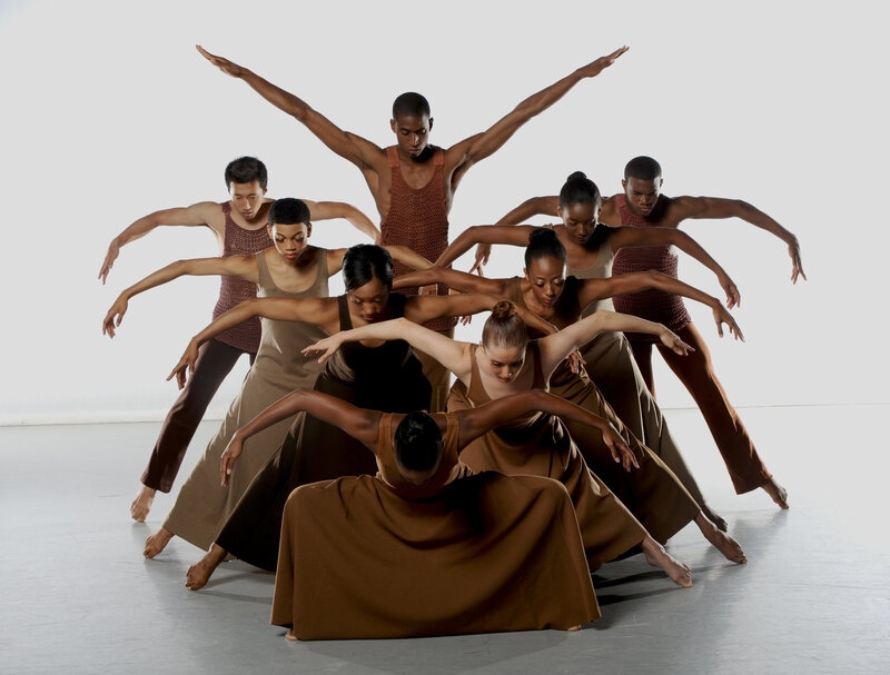 Dancers in earth-toned costumes