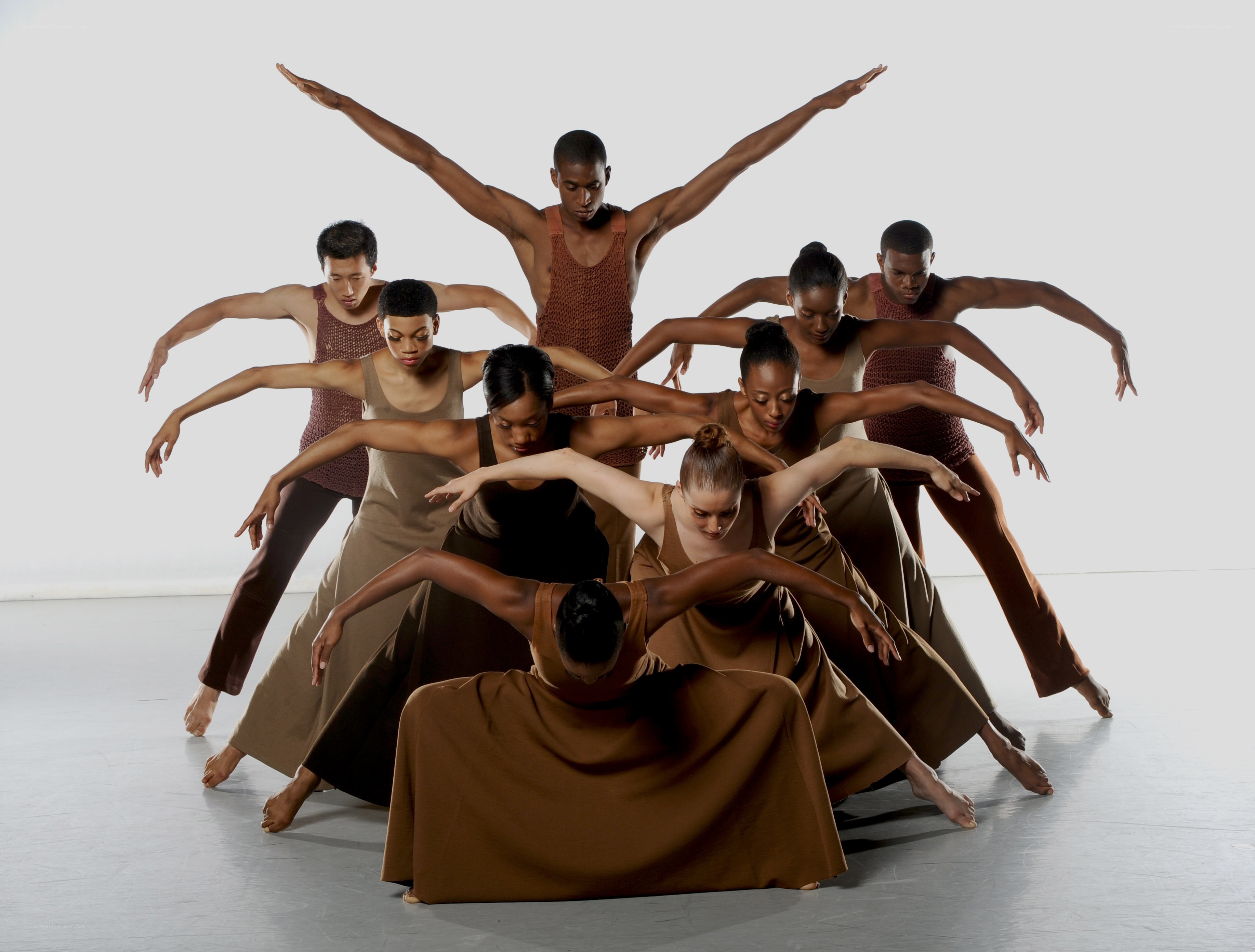 Dancers in earth-toned costumes
