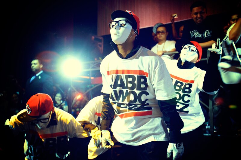 Dancers in masks on stage