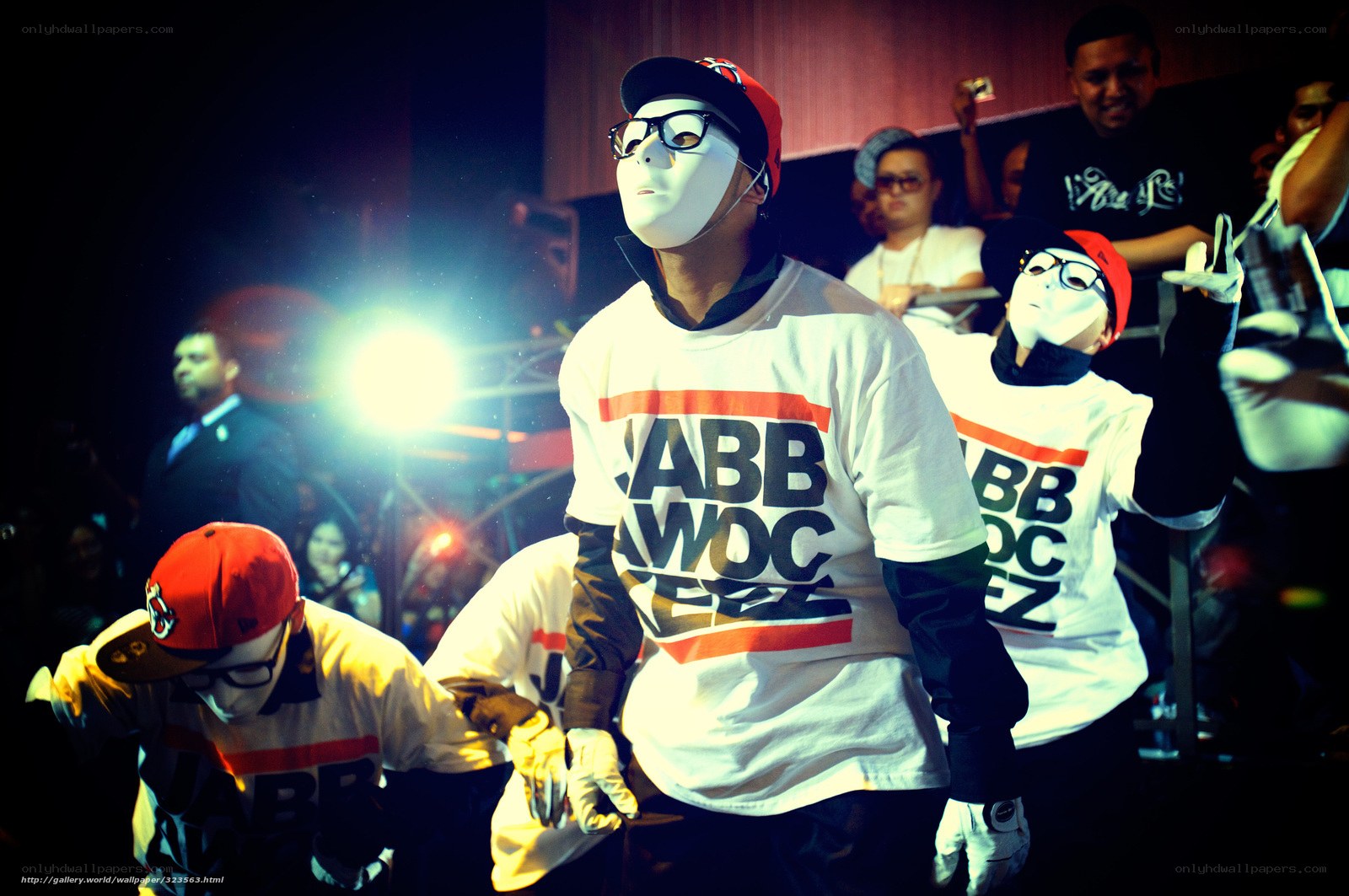 Dancers in masks on stage