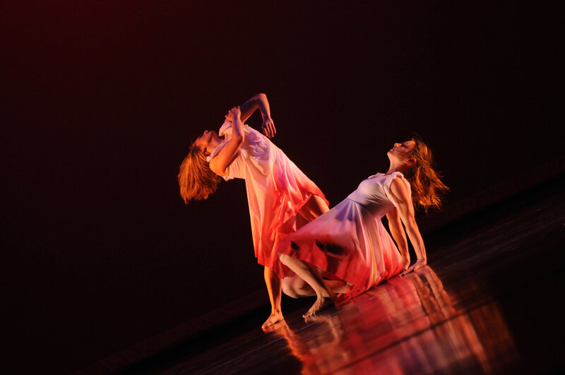 Dancers in red-lit performance