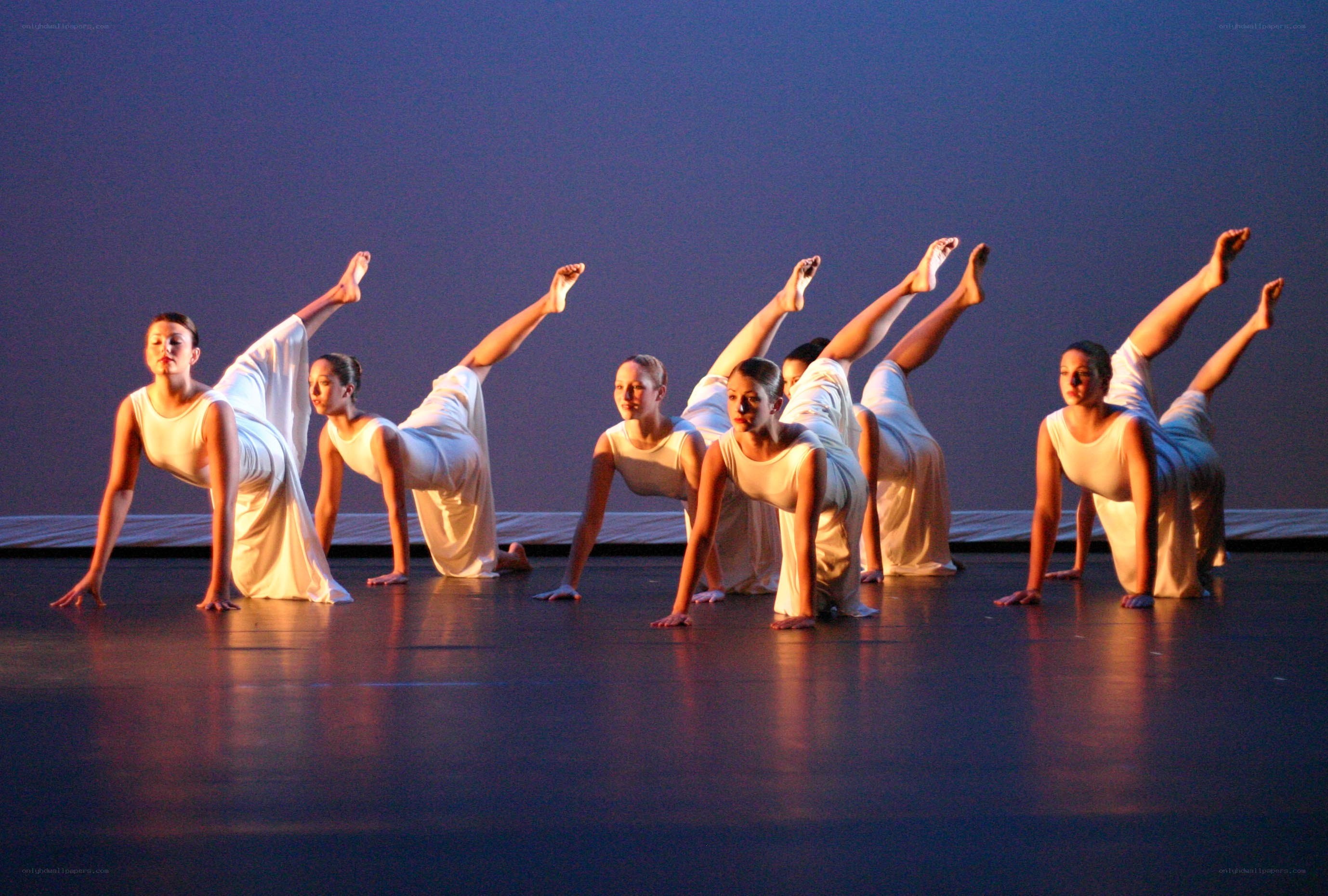 Dancers in white on stage
