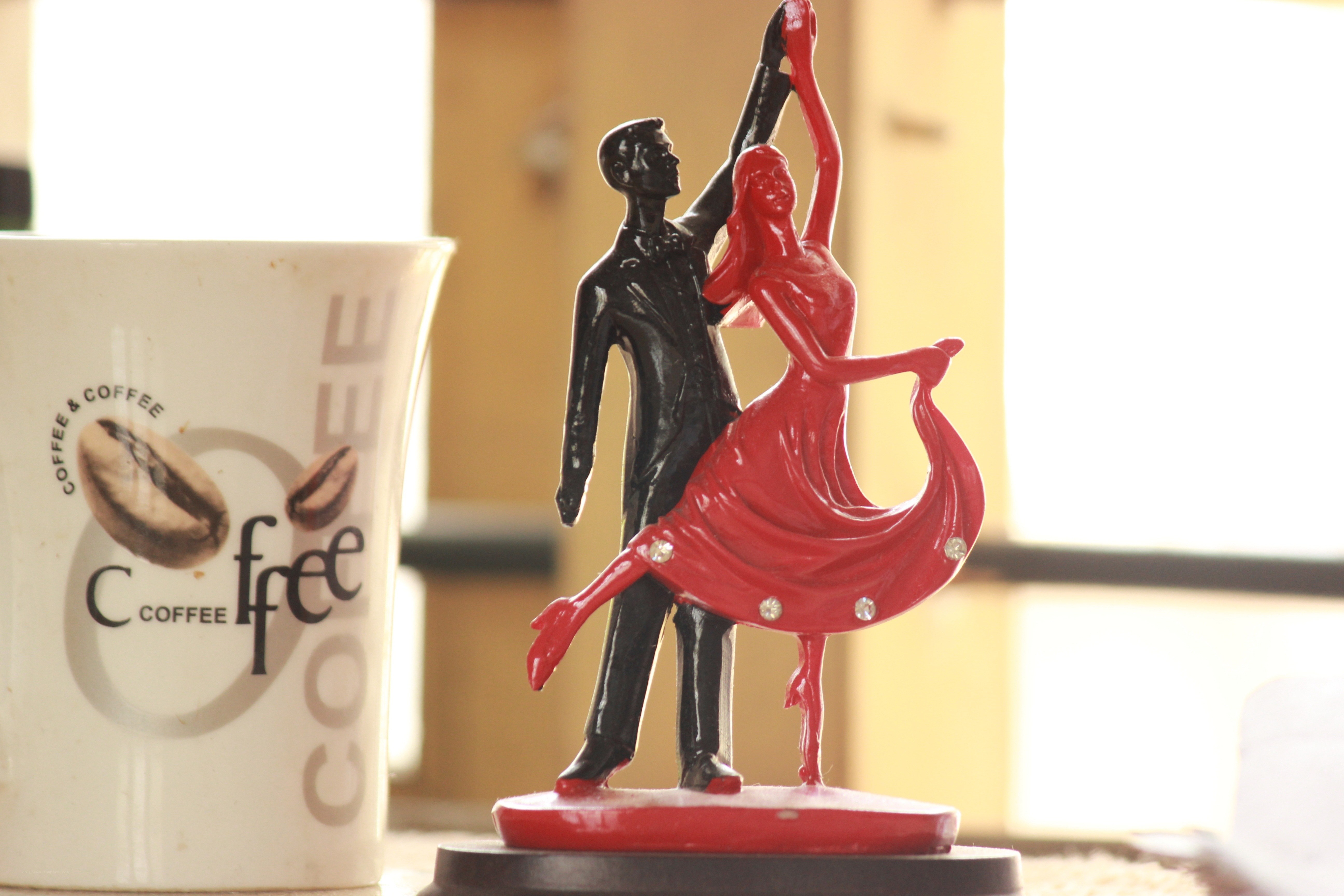 Dancing couple figurine with coffee cup