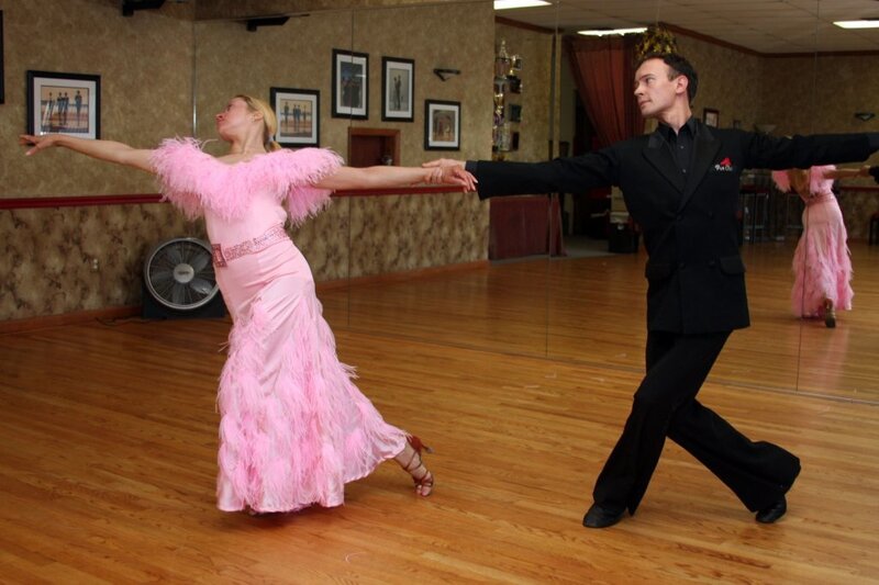 Dancing couple in ballroom attire