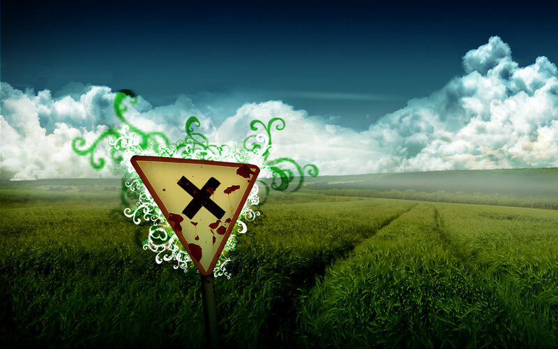 Danger sign in a green field
