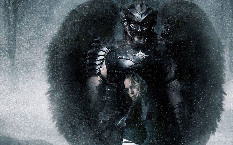 Dark angel with woman in snow